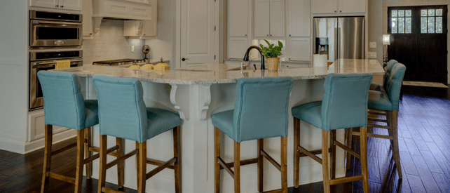 an all white kitchen with blue chairs