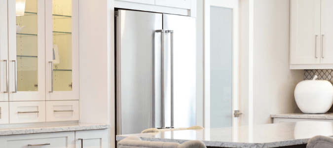 a refrigerator in a white kitchen